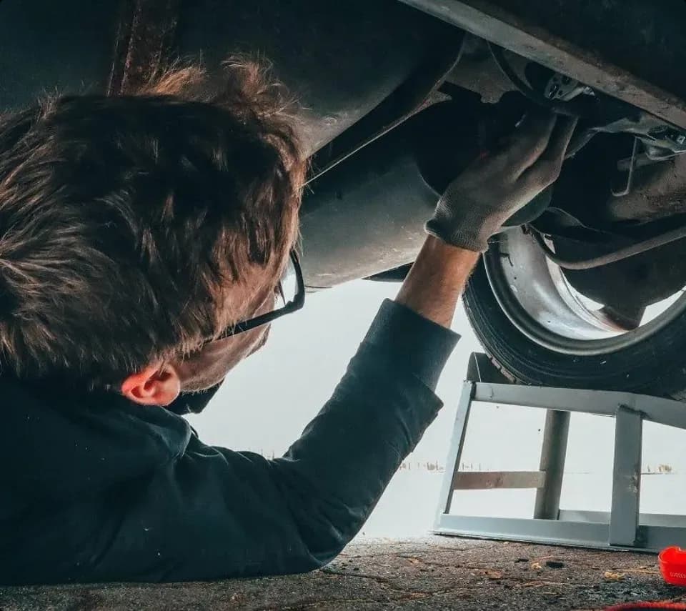 Technicians servicing a fleet vehicle