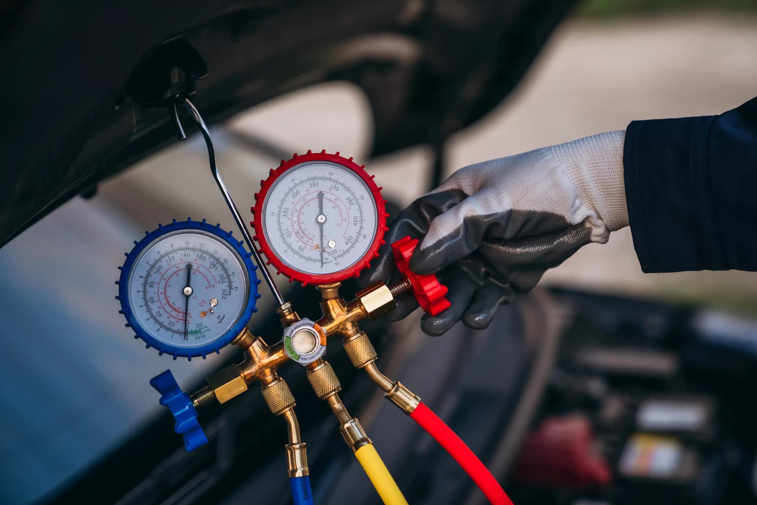 Car aircon regas equipment connected to a vehicle