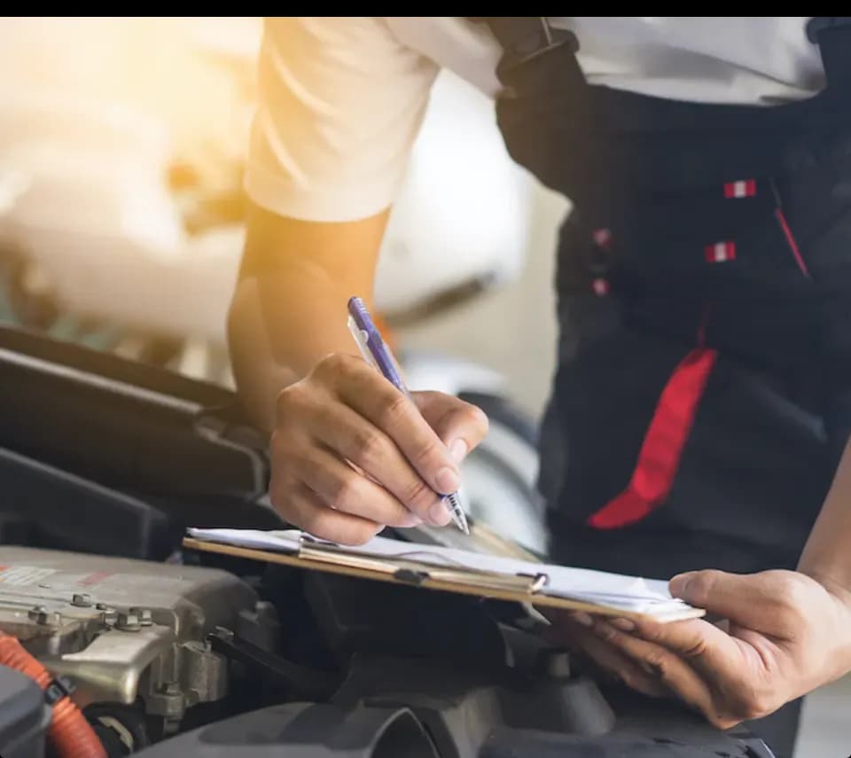 Technician writing vehicle notes