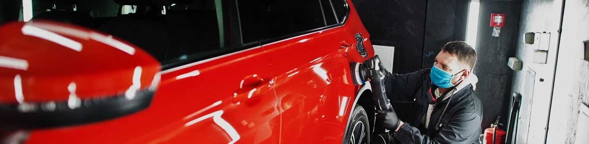 Car scratch repair polishing a red vehicle
