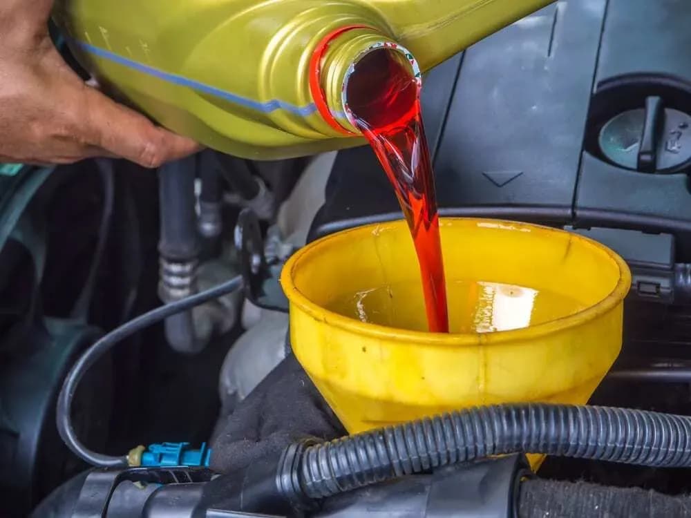 Technician preparing transmission-fluid service