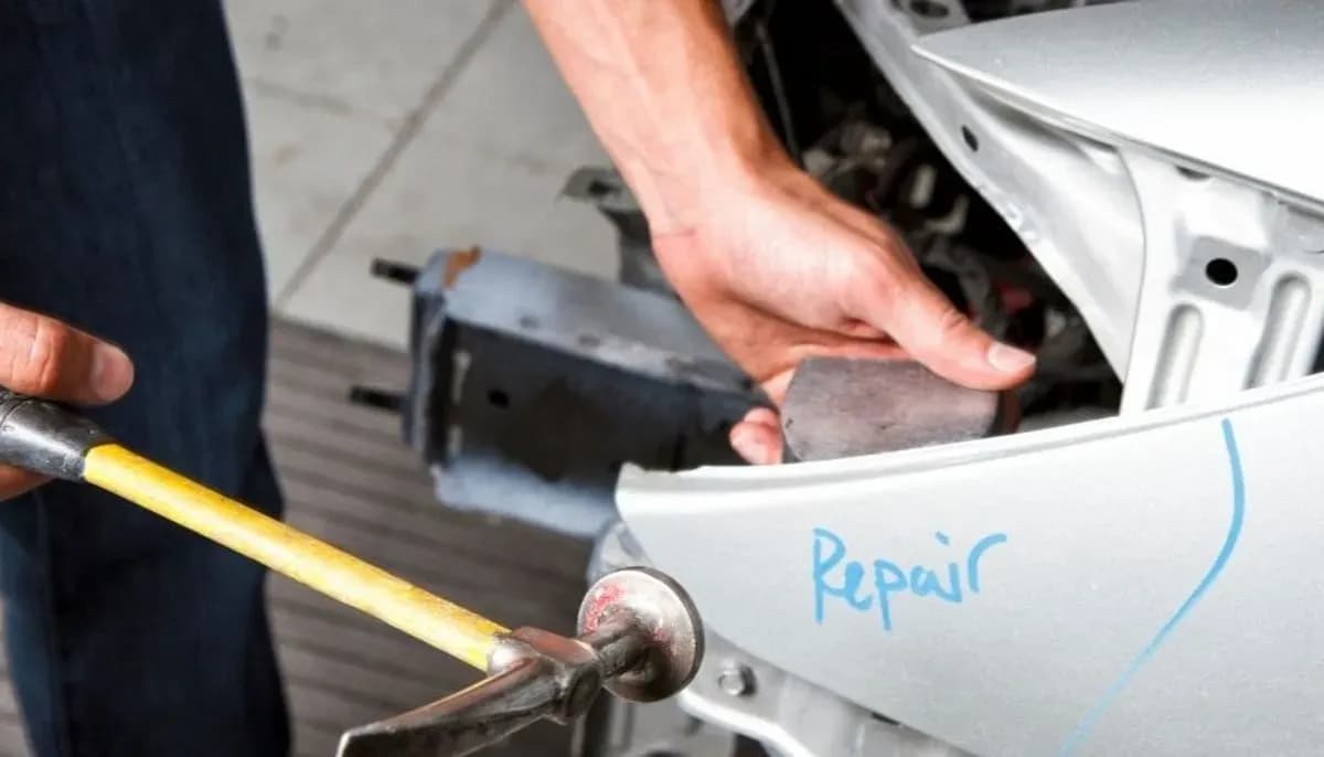 Car panel beating repair in progress