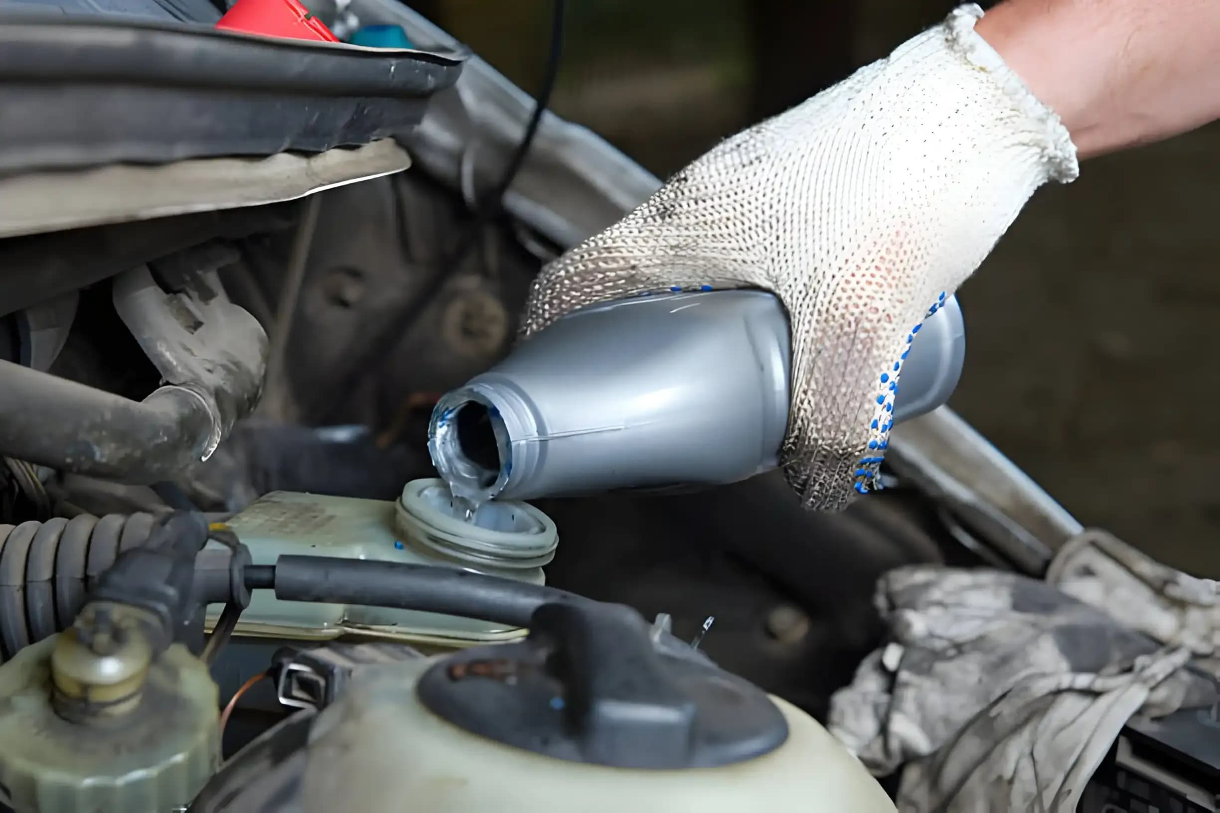 Brake fluid being poured into a vehicle reservoir