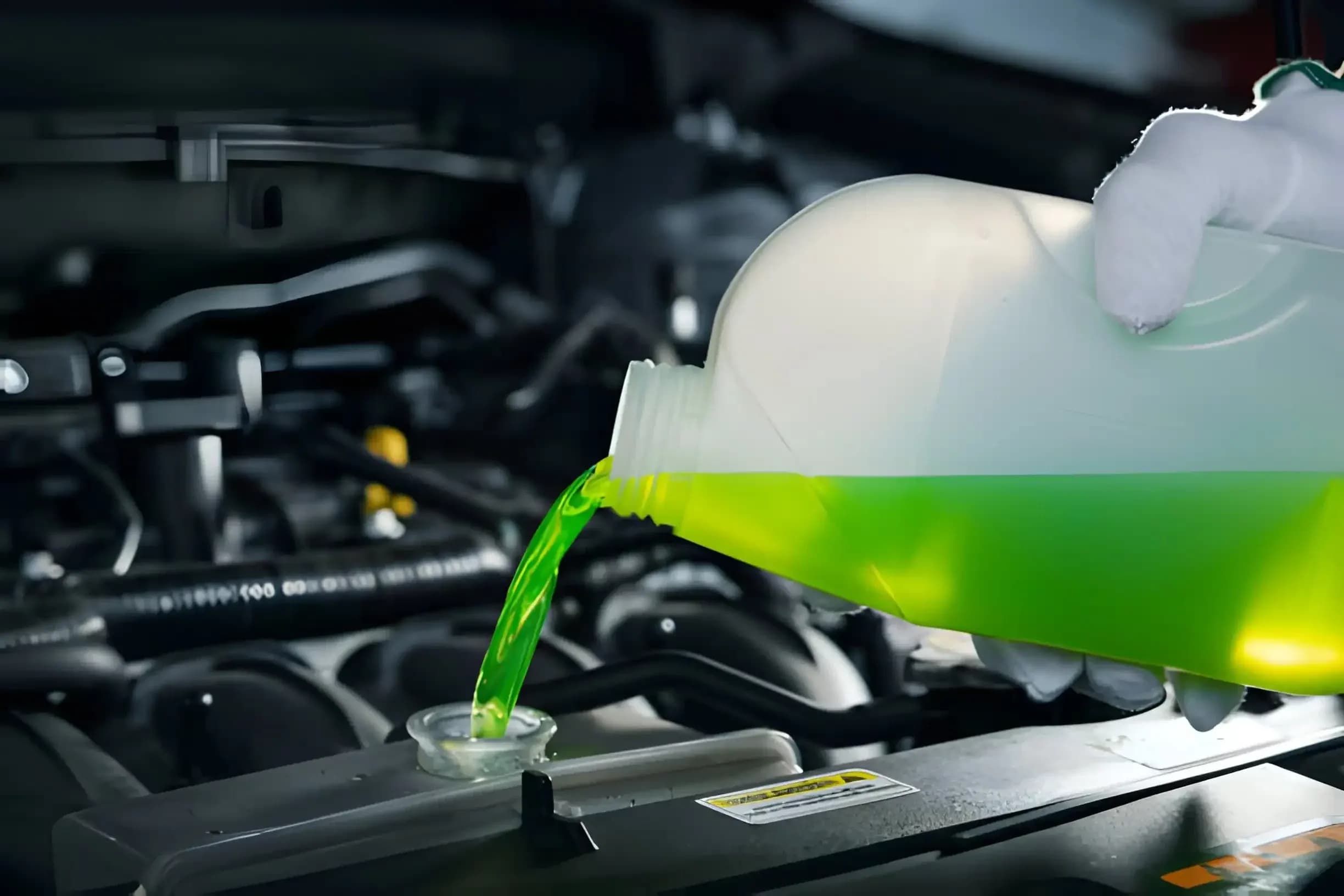 Green engine coolant being poured into a vehicle